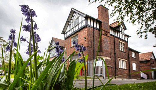 The outside of a big old building with gardens, Glyn Wyla Community Enterprise